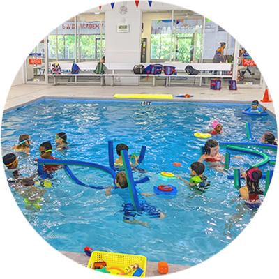 A bunch of children playing in the pool.