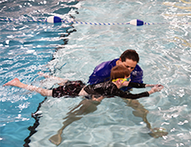 Swimming instructors teaching a swim class.